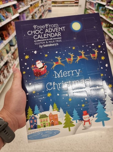 hand holding free from advent calendar at the supermarket